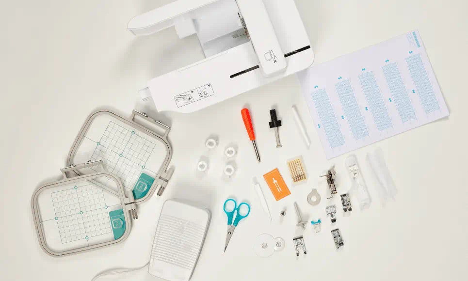 Brother Innov-is M380D Sewing & Embroidery Machine with its full range of accessories, including embroidery hoops, scissors, bobbins, and a threading guide.