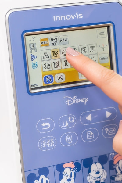 Brother Innov-is M380D: Close-up of LCD colour touch display demonstrating embroidery letter selection