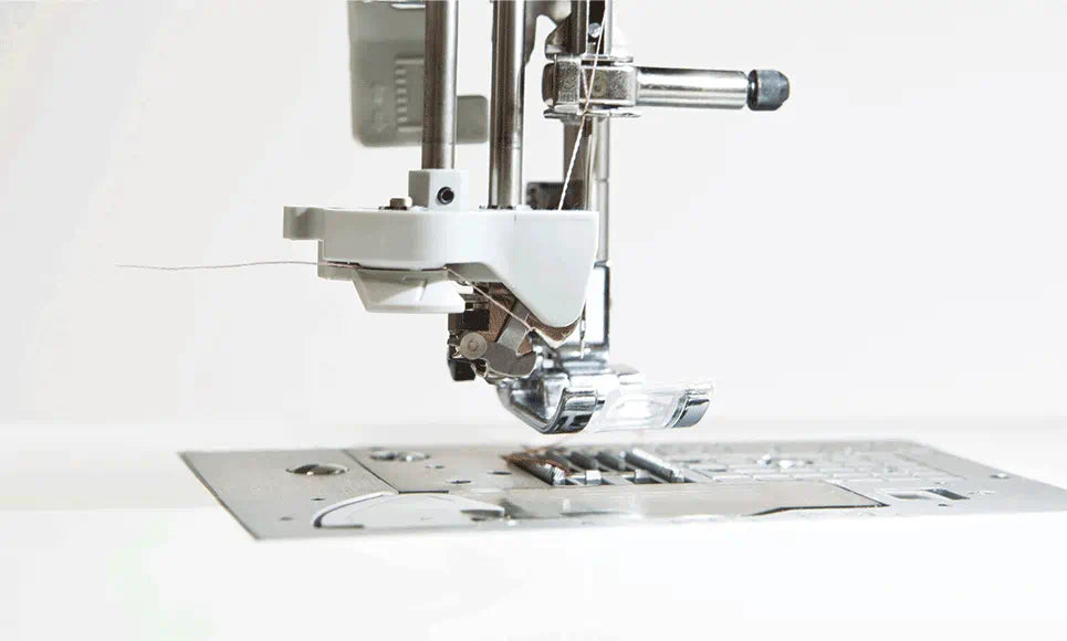 Detailed image of the Brother Innov-is F420 sewing machine's advanced needle threading system, highlighting the precision of the mechanism and the thread in action.