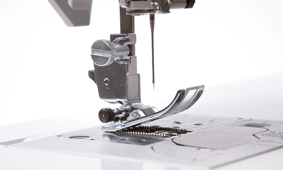 Close view of the Brother Innov-is NV1800Q’s needle and foot with ICAPS feature, highlighting the precision in stitch placement and fabric handling.
