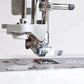 Alt description: "Detailed view of the Brother Innov-is NV1800Q's needle area showcasing the advanced needle threading system and the clear presser foot for precision sewing.