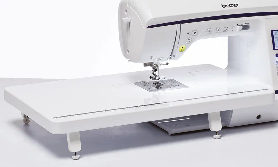 Alt description: "Brother Innov-is NV1800Q sewing and quilting machine featuring a large, extended wide table for increased workspace, with easy-to-access control panel and advanced needle threading system.